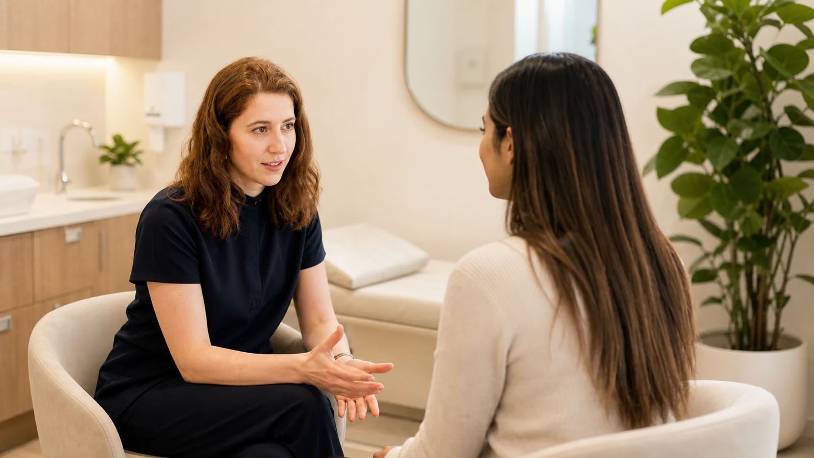 Clinician and patient in a calm Her Health and Aesthetics consultation room